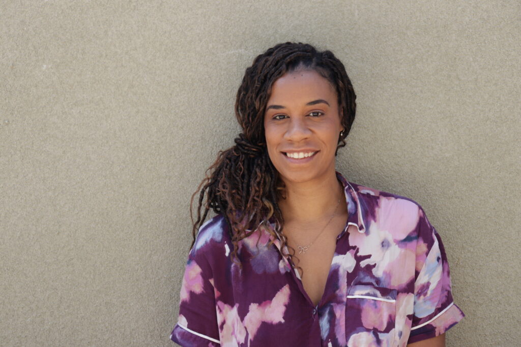 Erica Jones Adams in purple floral blouse